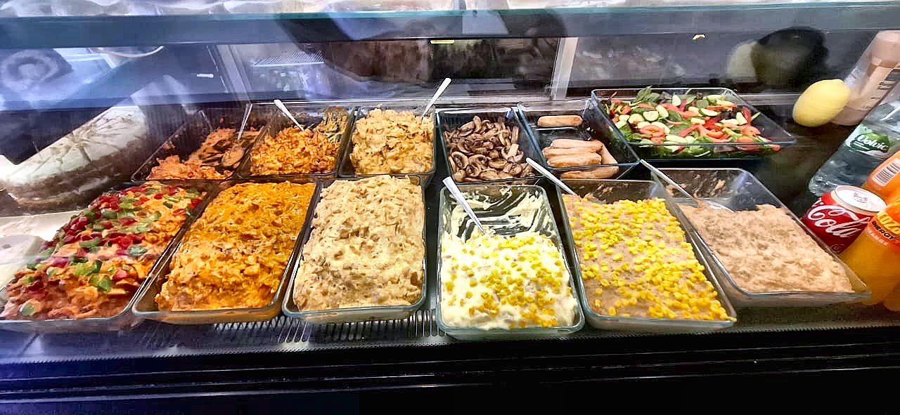 Hot fillings and salads laid out on the counter