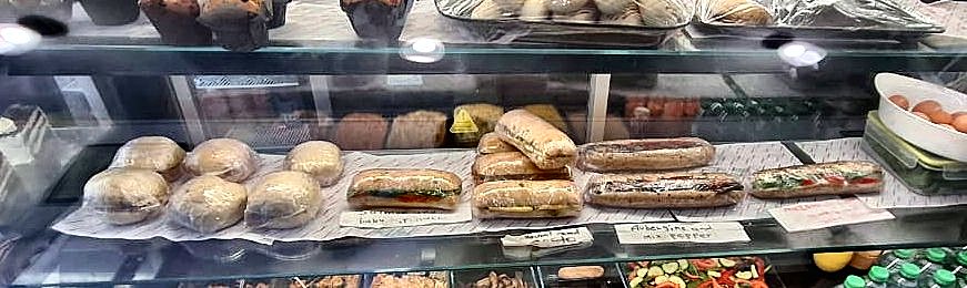 Freshly made baguettes and sandwiches on the counter shelf