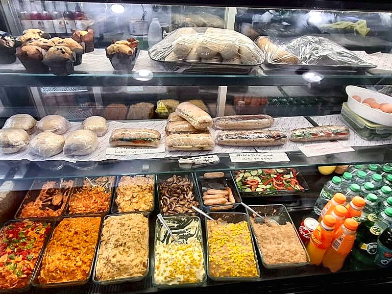 The deli case — baguettes, salads and hot fillings