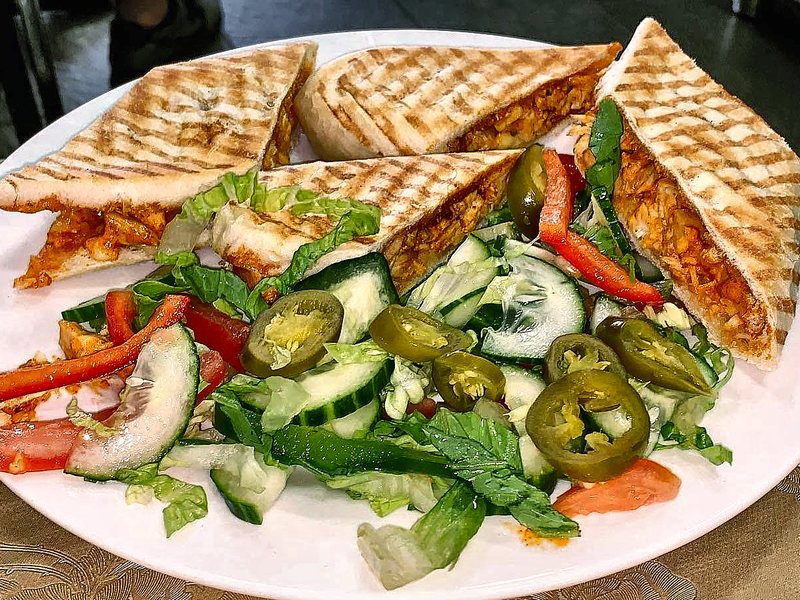 Chicken tikka panini at Cafe Royal, pressed and served with salad and jalapeños